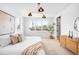 Bright bedroom with hardwood floors, large windows, contemporary lighting, and a stylish dresser for a comfortable retreat at 2926 S Cherokee St, Englewood, CO 80110