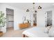 Bright bedroom with modern chandelier, view of staircase and a glimpse into the walk-in closet at 2926 S Cherokee St, Englewood, CO 80110