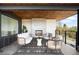 Cozy outdoor deck featuring a stone fireplace and comfortable seating perfect for relaxing and entertaining at 2926 S Cherokee St, Englewood, CO 80110