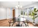 Bright dining room featuring wood floors, natural light, and modern chandelier at 2926 S Cherokee St, Englewood, CO 80110