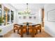 Bright dining room with modern chandelier, stylish decor, and hardwood floors at 2926 S Cherokee St, Englewood, CO 80110