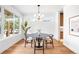 Bright dining room featuring wood floors, natural light, and modern chandelier at 2926 S Cherokee St, Englewood, CO 80110