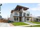 Contemporary home featuring clean lines, a second-story balcony, and lush green lawn at 2926 S Cherokee St, Englewood, CO 80110
