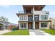 Stunning modern exterior with a second-story balcony and manicured front lawn at 2926 S Cherokee St, Englewood, CO 80110