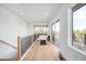 Bright hallway with hardwood floors leads to an open deck featuring an inviting space for relaxation or entertainment at 2926 S Cherokee St, Englewood, CO 80110