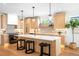 Open-concept kitchen with a large island, sleek appliances, and modern lighting at 2926 S Cherokee St, Englewood, CO 80110