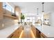Modern kitchen featuring sleek countertops, wood cabinetry, and an open layout flowing into the living area at 2926 S Cherokee St, Englewood, CO 80110