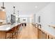 Bright, open-concept living space featuring hardwood floors, modern lighting, and a sleek kitchen with a large island at 2926 S Cherokee St, Englewood, CO 80110