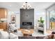 Open living area featuring a fireplace, stylish decor, and modern lighting at 2926 S Cherokee St, Englewood, CO 80110