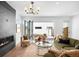 Elegant living room with fireplace and access to the outdoor patio through folding glass doors at 2926 S Cherokee St, Englewood, CO 80110