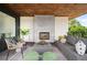 Outdoor living space with sleek fireplace, comfortable seating, and wooded ceiling at 2926 S Cherokee St, Englewood, CO 80110
