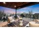 Inviting outdoor lounge area with comfortable seating and a stunning sunset view from the deck at 2926 S Cherokee St, Englewood, CO 80110