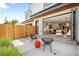 Outdoor patio with modern seating and seamless transition to indoor living space via large glass doors at 2926 S Cherokee St, Englewood, CO 80110