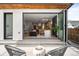 Inviting outdoor patio with comfortable seating, a modern fire pit, and seamless indoor-outdoor living through folding glass doors at 2926 S Cherokee St, Englewood, CO 80110