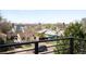 Neighborhood view from a home features an open sky and glimpses of neighboring houses and lush trees at 2926 S Cherokee St, Englewood, CO 80110