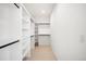 A walk-in closet with white walls and open shelving with black rods at 2926 S Cherokee St, Englewood, CO 80110