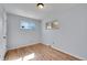 Bright bedroom featuring wood floors, neutral walls, natural light, and a closet at 414 S Nelson S St, Lakewood, CO 80226