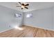 Cozy bedroom featuring wood floors, neutral walls, ceiling fan, and sunlit windows at 414 S Nelson S St, Lakewood, CO 80226