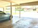 Carport featuring blue car with tree and residential view at 414 S Nelson S St, Lakewood, CO 80226