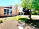 Close up of a charming single-story home with brick facade, landscaped front yard, and covered parking at 414 S Nelson S St, Lakewood, CO 80226