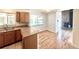 Open kitchen and breakfast nook with granite countertops, wood cabinetry, and hardwood floors at 414 S Nelson S St, Lakewood, CO 80226