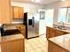 Kitchen with stainless steel appliances, granite countertops, tile floors, and wood cabinetry at 414 S Nelson S St, Lakewood, CO 80226