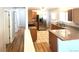 Bright kitchen featuring stainless steel appliances, granite countertops, tile floors, and an eat-in bar at 414 S Nelson S St, Lakewood, CO 80226