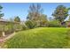 This backyard is complete with lush green lawn, mature trees, and a fenced in border at 7901 E Kenyon Dr, Denver, CO 80237