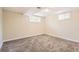 Finished basement space with neutral carpeting, white trim, and windows for natural light at 7901 E Kenyon Dr, Denver, CO 80237