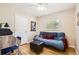 Functional bedroom with futon, desk, hardwood floors, and natural light at 7901 E Kenyon Dr, Denver, CO 80237
