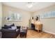 Comfortable bedroom setup with hardwood floors, ample natural light, and cozy seating at 7901 E Kenyon Dr, Denver, CO 80237