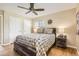Comfortable bedroom with hardwood floors, two windows, and neutral wall color at 7901 E Kenyon Dr, Denver, CO 80237
