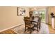 Classic dining area featuring hardwood floors, a dining table, and views of the backyard at 7901 E Kenyon Dr, Denver, CO 80237