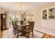Inviting dining room with hardwood floors, a grand table, and sliding glass doors to outdoor space at 7901 E Kenyon Dr, Denver, CO 80237