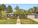 Charming brick home featuring a well-manicured front yard and a quaint walkway leading to the entrance at 7901 E Kenyon Dr, Denver, CO 80237