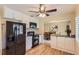 Modern kitchen features white cabinets, sleek black appliances, and hardwood floors at 7901 E Kenyon Dr, Denver, CO 80237