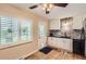 Cozy kitchen area featuring a window with shutters, sleek countertops, and hardwood floors at 7901 E Kenyon Dr, Denver, CO 80237