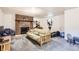 A comfortable living room with a brick fireplace, futon sofa, exercise equipment, and carpeted floors at 7901 E Kenyon Dr, Denver, CO 80237