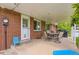 This covered brick patio features an outdoor dining set, grill, and ample space for outdoor enjoyment at 7901 E Kenyon Dr, Denver, CO 80237