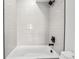 Clean bathroom with white subway tiles and a bathtub at 1418 Pierce St, Lakewood, CO 80214
