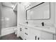 Modern bathroom with double vanity, a soaking tub, and shower at 1418 Pierce St, Lakewood, CO 80214