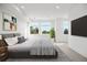 Bright bedroom with large windows and a flat-screen TV at 1418 Pierce St, Lakewood, CO 80214