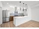 Modern kitchen with stainless steel appliances and an island at 1418 Pierce St, Lakewood, CO 80214