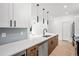 Modern kitchen with stainless steel appliances and an island at 1418 Pierce St, Lakewood, CO 80214