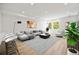 Open living room with sectional sofa and large windows at 1418 Pierce St, Lakewood, CO 80214