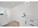 Stylish wet bar with white cabinetry and quartz countertop at 1418 Pierce St, Lakewood, CO 80214