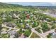 An aerial perspective of a home surrounded by trees in a suburban setting with mountain views at 1100 E Harvey St, Castle Rock, CO 80108