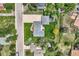 A bird's eye view shows a well-maintained property with a green lawn and mature trees, plus a long driveway at 1100 E Harvey St, Castle Rock, CO 80108