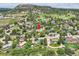 An aerial view of a home situated in a verdant suburban area, with scenic mountain backdrop at 1100 E Harvey St, Castle Rock, CO 80108