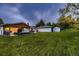 Aerial view of the backyard featuring a lounge area, patio dining, and landscaping at 1100 E Harvey St, Castle Rock, CO 80108